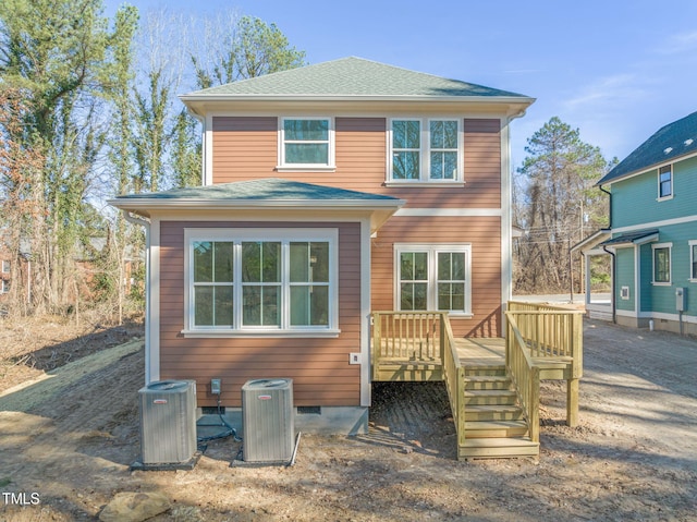 back of property with cooling unit and a wooden deck