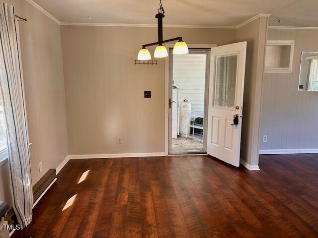 unfurnished dining area featuring crown molding and dark hardwood / wood-style flooring