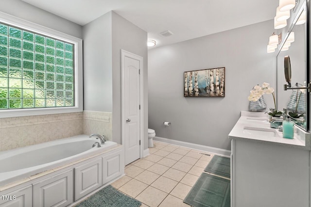 full bath featuring double vanity, toilet, tile patterned floors, baseboards, and a garden tub