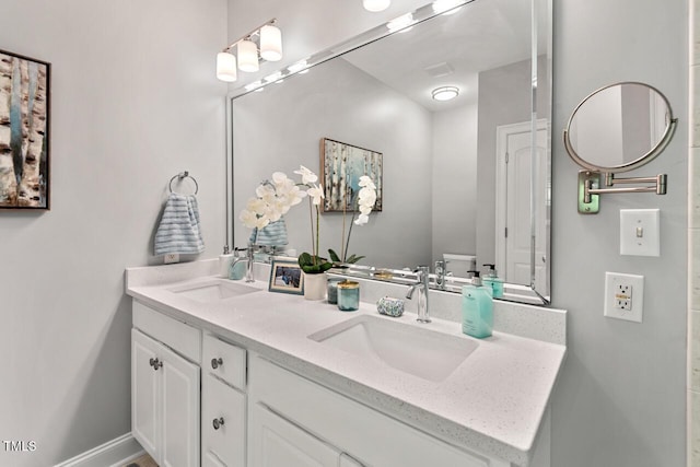 full bathroom featuring double vanity and a sink