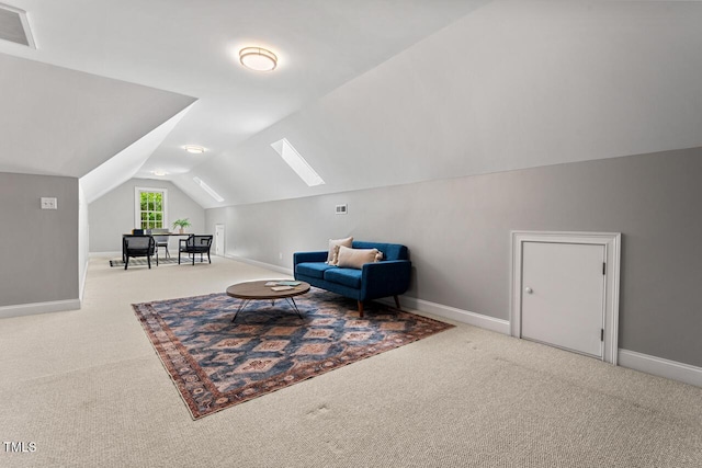 sitting room with carpet floors, visible vents, baseboards, and lofted ceiling
