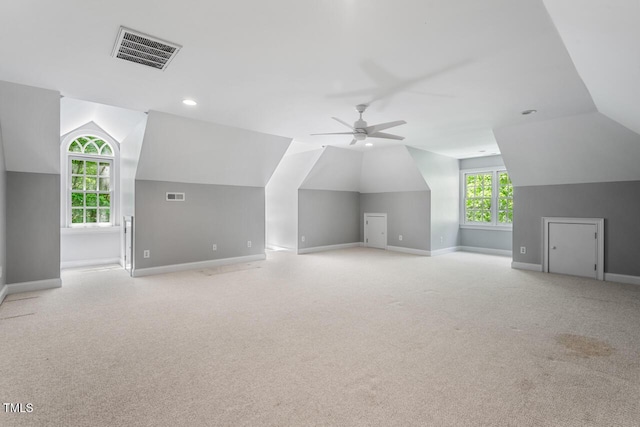 bonus room with visible vents, baseboards, and lofted ceiling