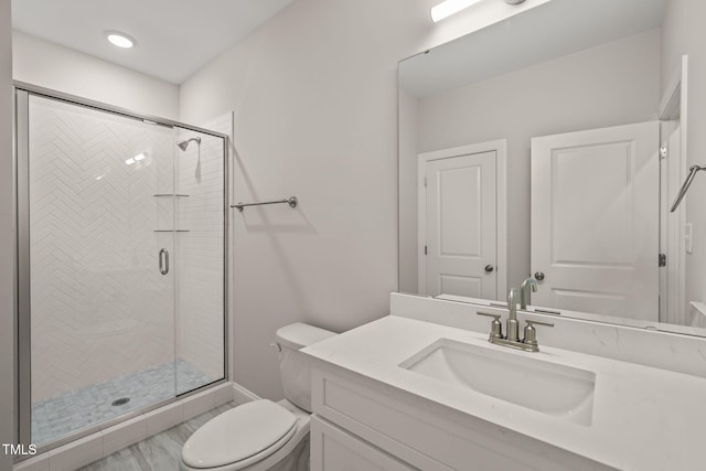 full bathroom with vanity, a shower stall, and toilet