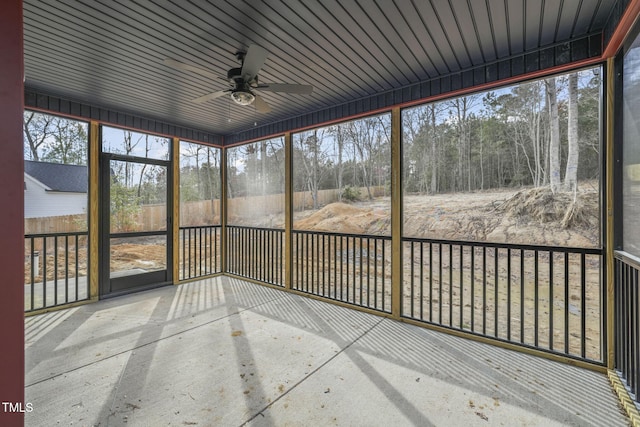 unfurnished sunroom featuring ceiling fan