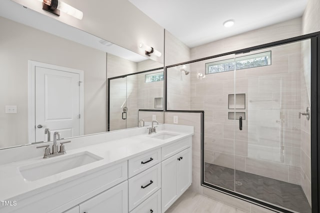 bathroom featuring double vanity, a sink, and a shower stall