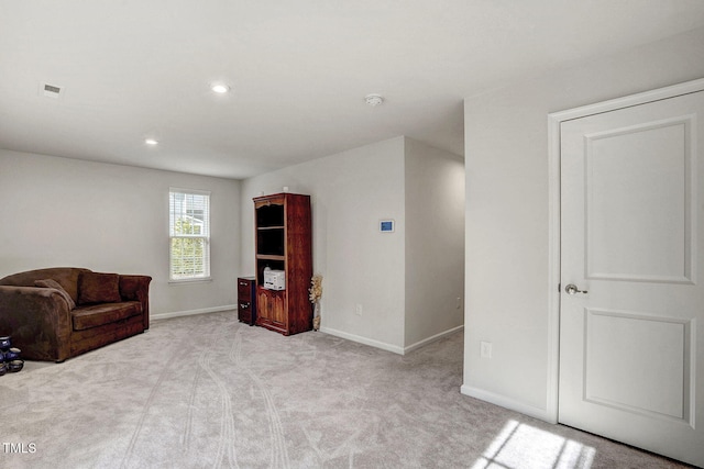 sitting room with light colored carpet, visible vents, baseboards, and recessed lighting