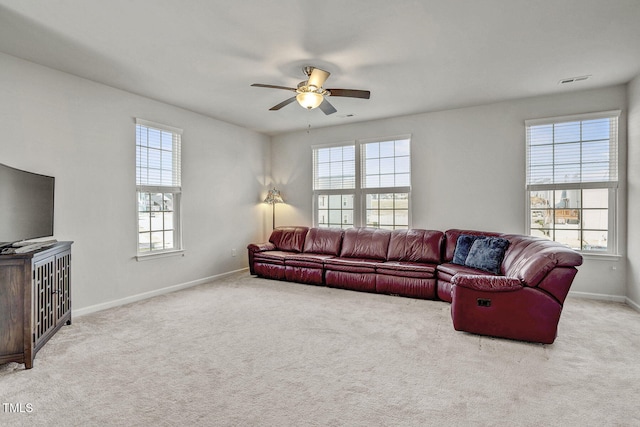 living room with light carpet, ceiling fan, and plenty of natural light