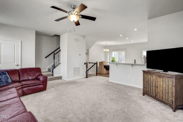 living area featuring light carpet, baseboards, stairs, and visible vents