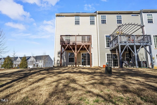 back of property with a lawn and a pergola