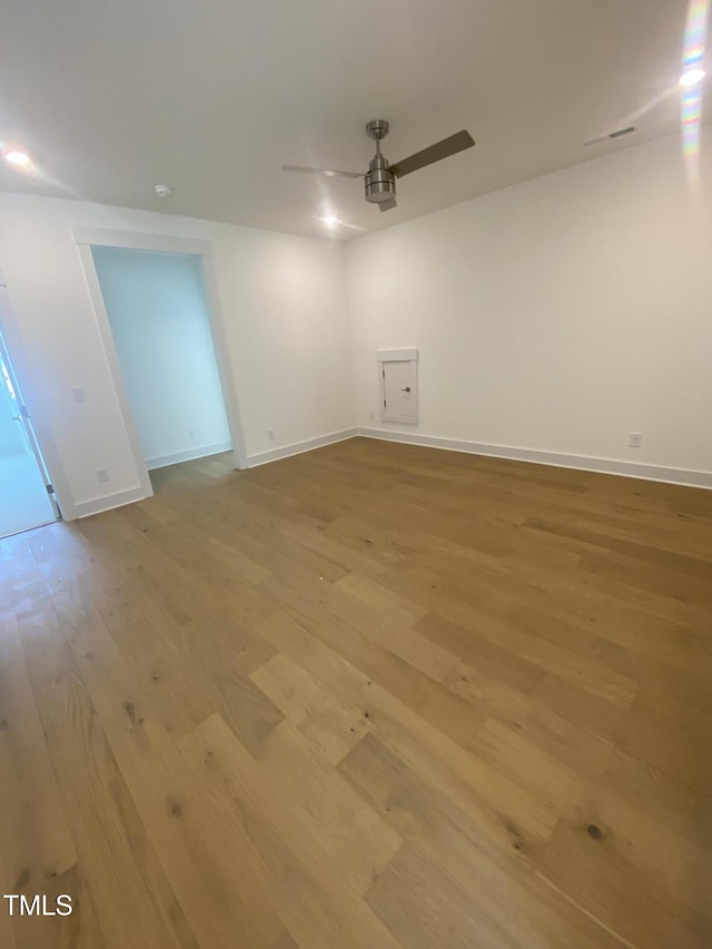 unfurnished room with light wood-style floors, baseboards, and ceiling fan