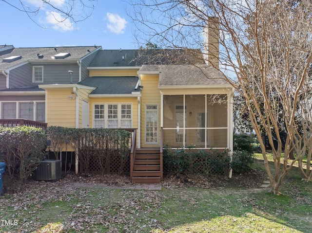 back of house with a deck, a lawn, cooling unit, and a sunroom