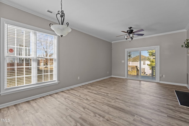 interior space with light wood-style floors, ceiling fan, baseboards, and crown molding