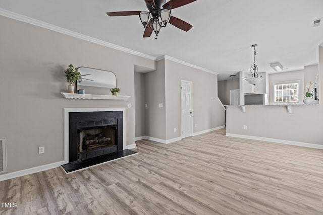 unfurnished living room featuring light wood finished floors, a fireplace, baseboards, and crown molding