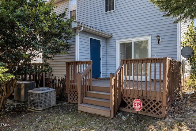 wooden deck featuring cooling unit