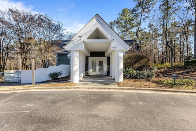 view of front of property featuring french doors and fence