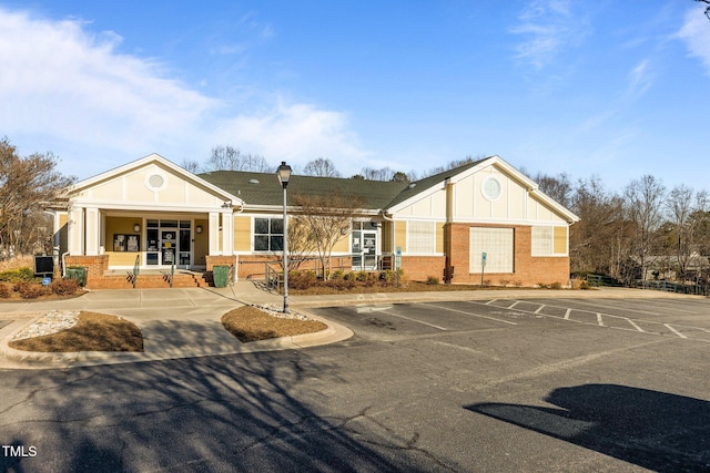 view of building exterior featuring uncovered parking