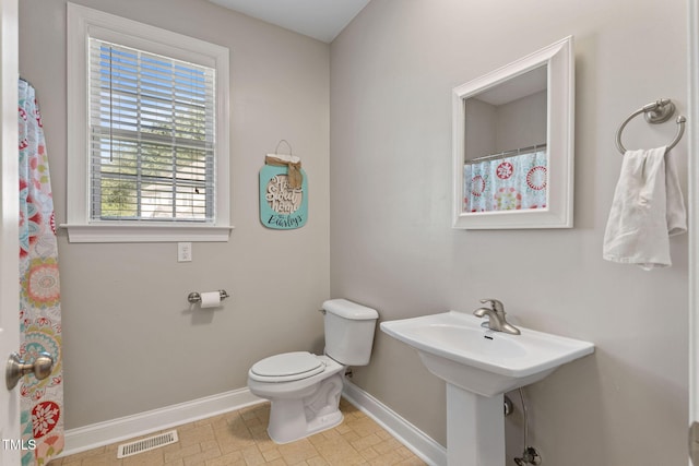 bathroom featuring sink and toilet