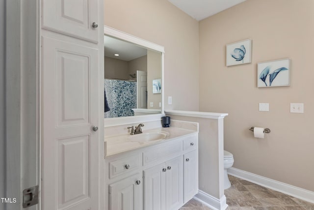 bathroom featuring vanity and toilet