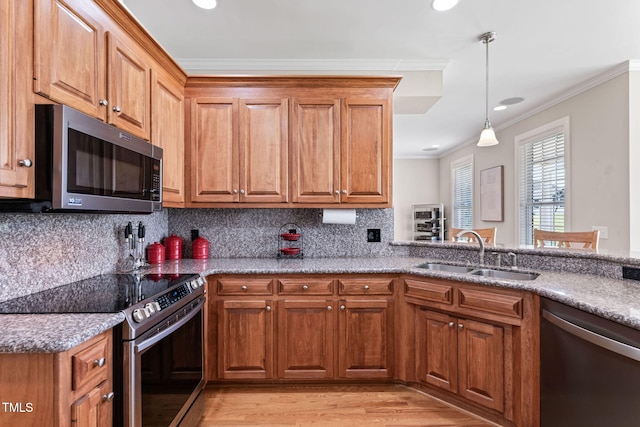 kitchen featuring appliances with stainless steel finishes, sink, backsplash, crown molding, and light stone countertops