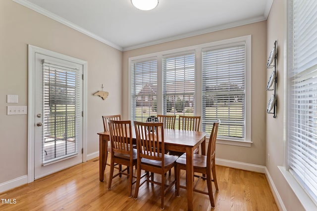 dining space with ornamental molding, light wood-type flooring, and a wealth of natural light