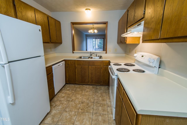 kitchen featuring a notable chandelier, white appliances, light tile patterned flooring, pendant lighting, and sink