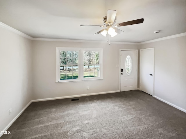 entryway featuring ornamental molding, dark colored carpet, and baseboards