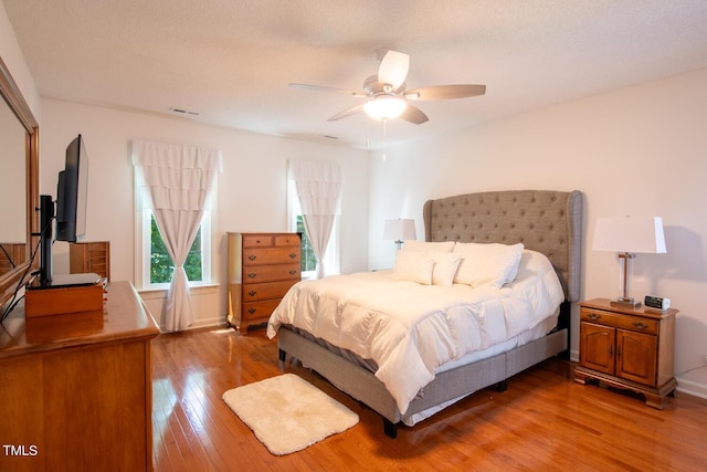 bedroom with ceiling fan and light wood-style flooring