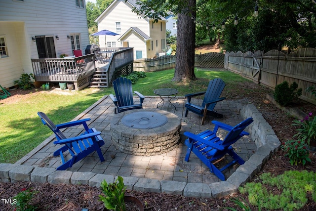 view of patio featuring a deck, a fenced backyard, and a fire pit