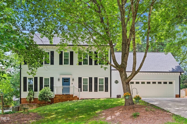 2006 Chedington Dr, Apex, NC 27502 - colonial-style house featuring an attached garage, concrete driveway, a front yard, and a shingled roof