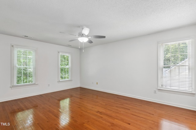 2006 Chedington Dr, Apex, NC 27502 - empty room with wood finished floors, a ceiling fan, and a textured ceiling