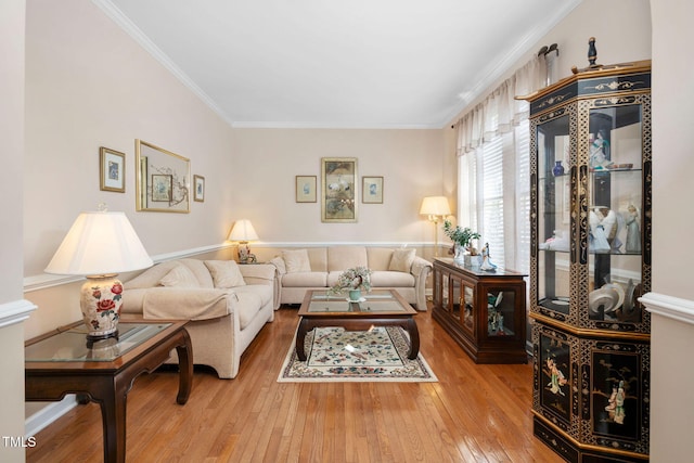 living area with hardwood / wood-style floors and crown molding