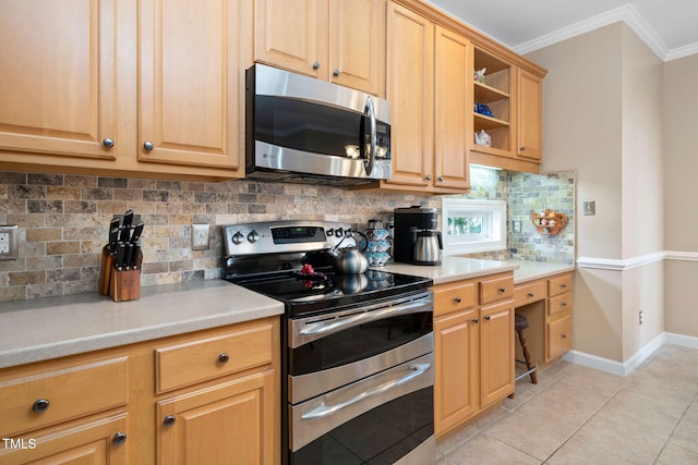 kitchen featuring light tile patterned flooring, stainless steel appliances, baseboards, light countertops, and crown molding