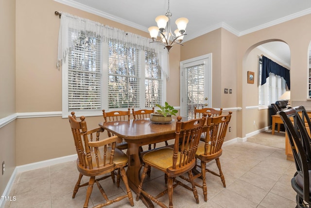 dining room with arched walkways, crown molding, baseboards, and light tile patterned floors