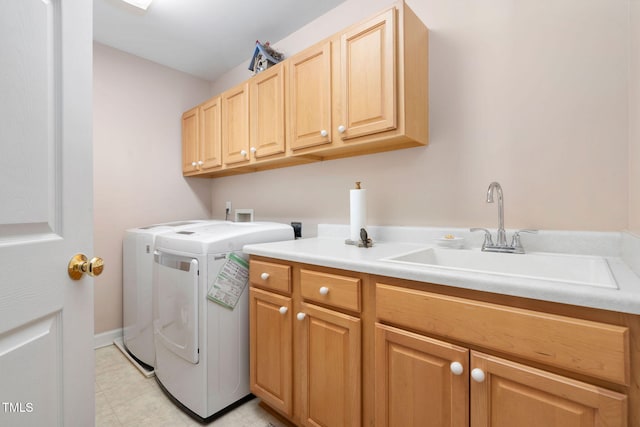 laundry area featuring a sink, cabinet space, and washer and dryer