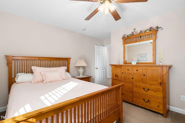 bedroom with ceiling fan, baseboards, and light colored carpet