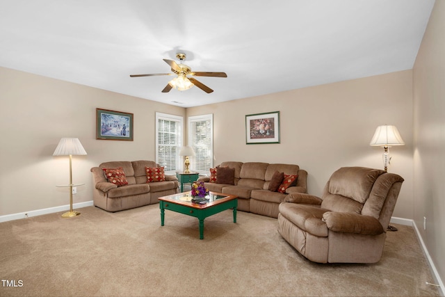 living area featuring a ceiling fan, carpet, and baseboards