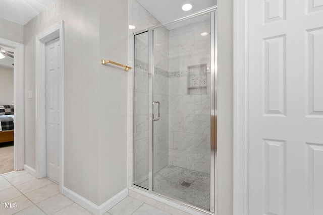 ensuite bathroom with ensuite bath, a shower stall, baseboards, and tile patterned floors