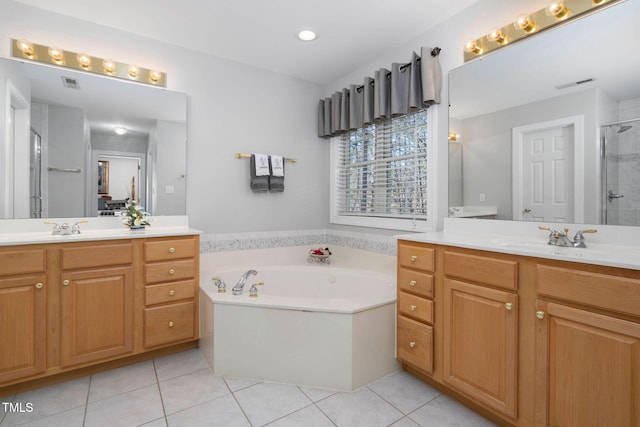 full bath with a garden tub, a sink, visible vents, a shower stall, and tile patterned floors