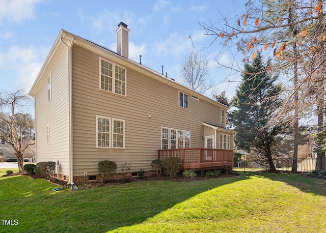 back of house featuring fence, a yard, crawl space, a wooden deck, and a chimney