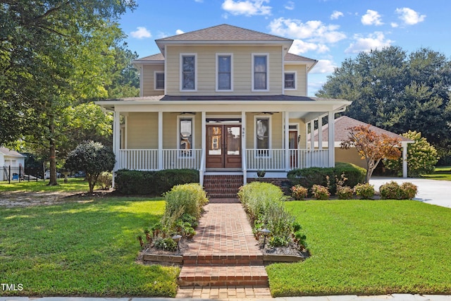 view of front of house with covered porch, driveway, and a front lawn