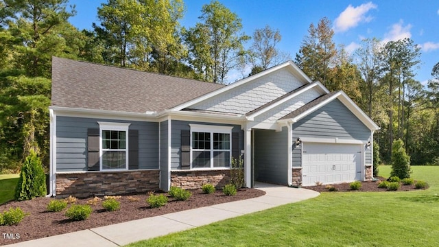 craftsman inspired home featuring a garage and a front yard