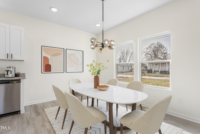 dining room featuring light wood-type flooring, an inviting chandelier, baseboards, and recessed lighting