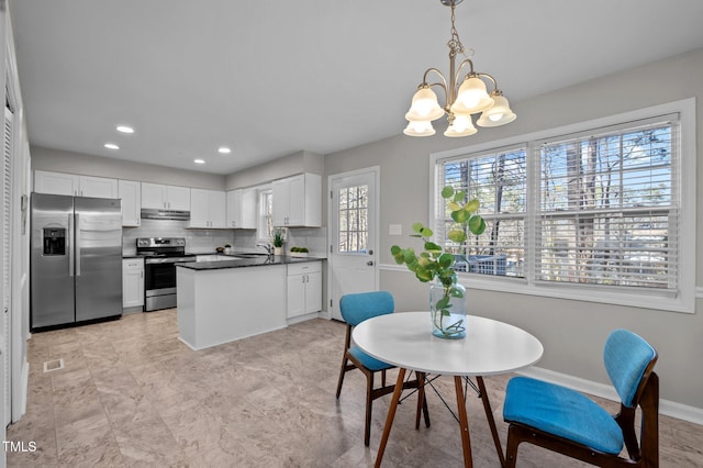 dining room featuring baseboards, visible vents, a chandelier, and recessed lighting