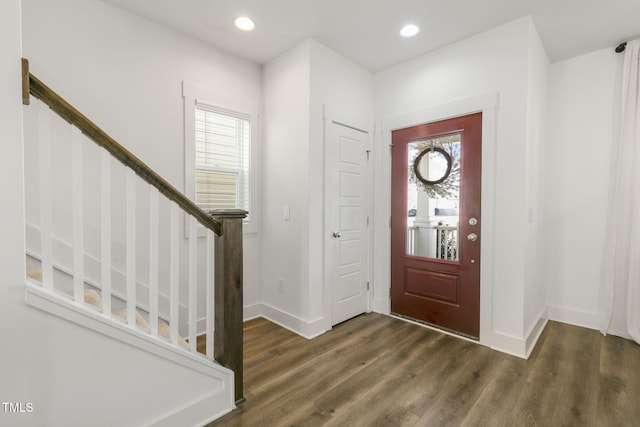 foyer entrance featuring dark wood-type flooring, recessed lighting, a healthy amount of sunlight, and stairway