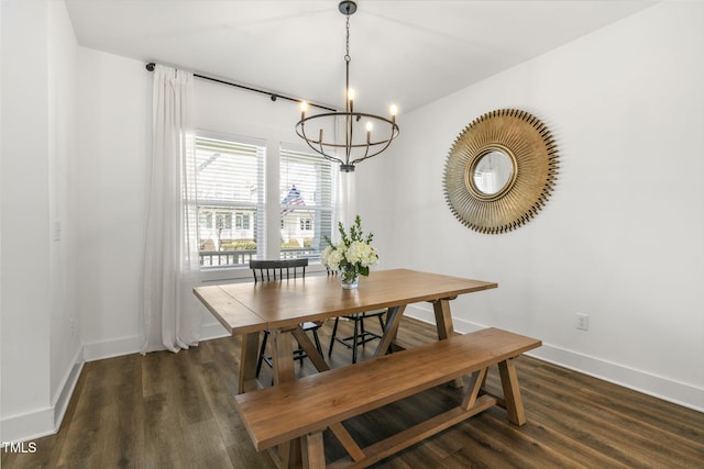 dining room with an inviting chandelier, baseboards, and wood finished floors