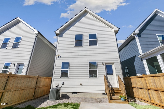 back of house featuring entry steps, crawl space, central AC, and fence private yard