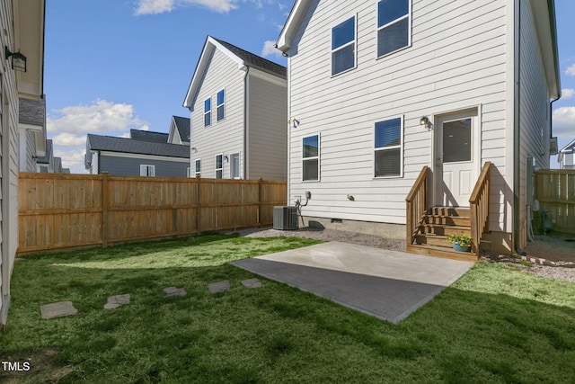 back of house featuring entry steps, central AC, fence, crawl space, and a lawn