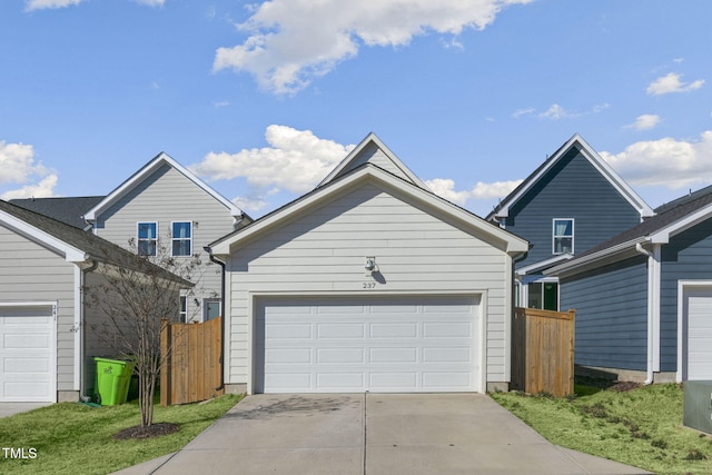 view of front of house with a garage, fence, and an outdoor structure