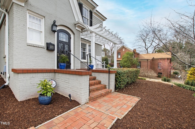 doorway to property featuring a pergola