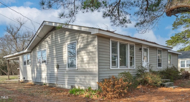 view of side of home featuring crawl space